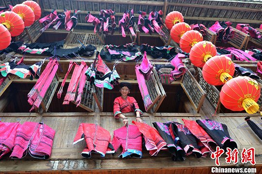 圖為紅瑤姑娘把紅衣晾曬出來。中新社發(fā) 韋吉陽 攝