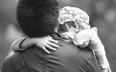 昨日，北京同仁醫(yī)院，被砍傷的彤彤趴在舅舅的肩上。他們剛剛掛完號，正準(zhǔn)備回旅館。新京報(bào)記者 尹亞飛 攝