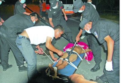 眾人合力將狂犬病發(fā)作的江某控制住。 孫東城 攝