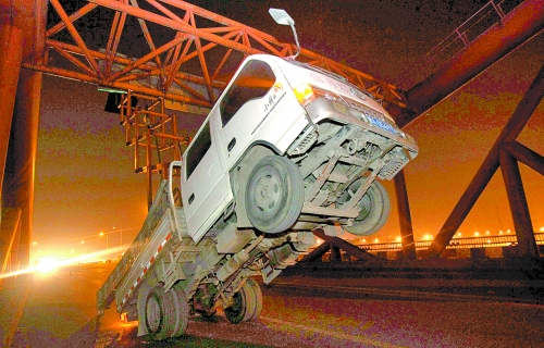 　車上升降機的工作臺被卡，車身前部高高翹起。