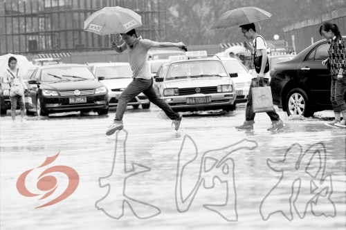 鄭州經(jīng)三路與北環(huán)交叉口處，積水較深，行人們不得不“練輕功”。 記者 白周峰 攝影