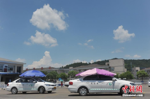 杭州一駕校現(xiàn)遮陽(yáng)新招 教練車車頂撐傘