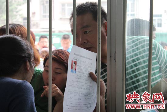 不少家長(zhǎng)擠在報(bào)名窗口前咨詢(xún)報(bào)名事宜。