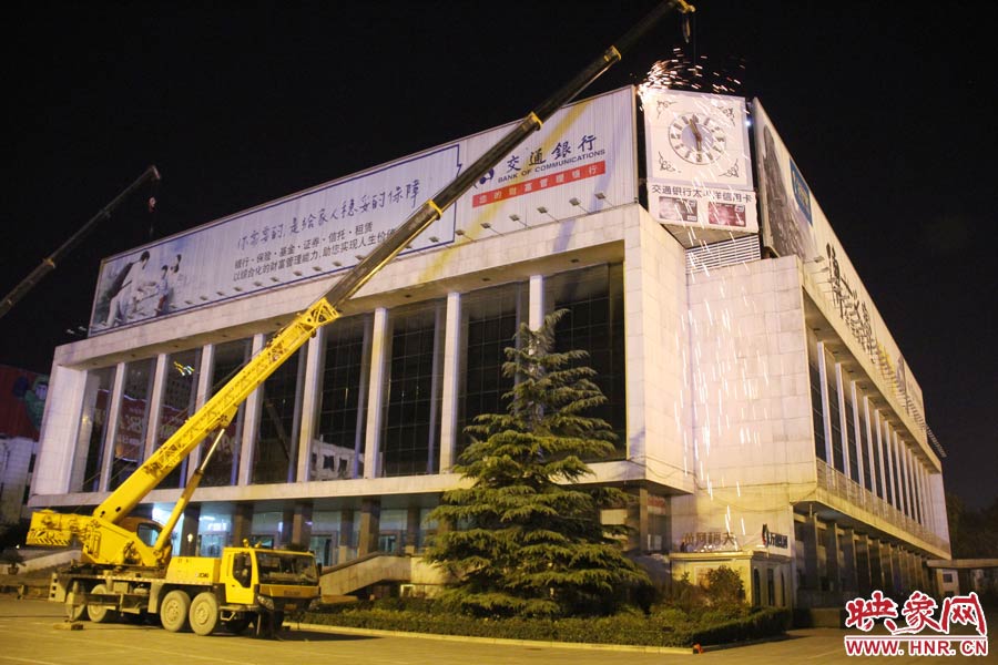 21點(diǎn)50分，切割機(jī)開始對(duì)中間最小的一塊牌進(jìn)行切割。頂著“呼呼”的寒風(fēng)，巨大廣告牌上火花四濺。