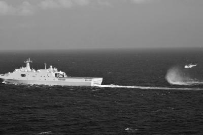 11日，抵達(dá)馬航飛機(jī)失聯(lián)海區(qū)的海軍井岡山艦與艦載直升機(jī)協(xié)同展開立體搜救行動(dòng)。新華社發(fā)