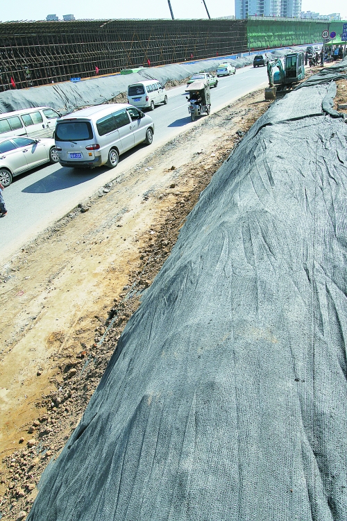 豐樂(lè)路與北三環(huán)交叉口，修路的土被歸置得整整齊齊，并用黑網(wǎng)覆蓋，既保暢通又避免了揚(yáng)塵。